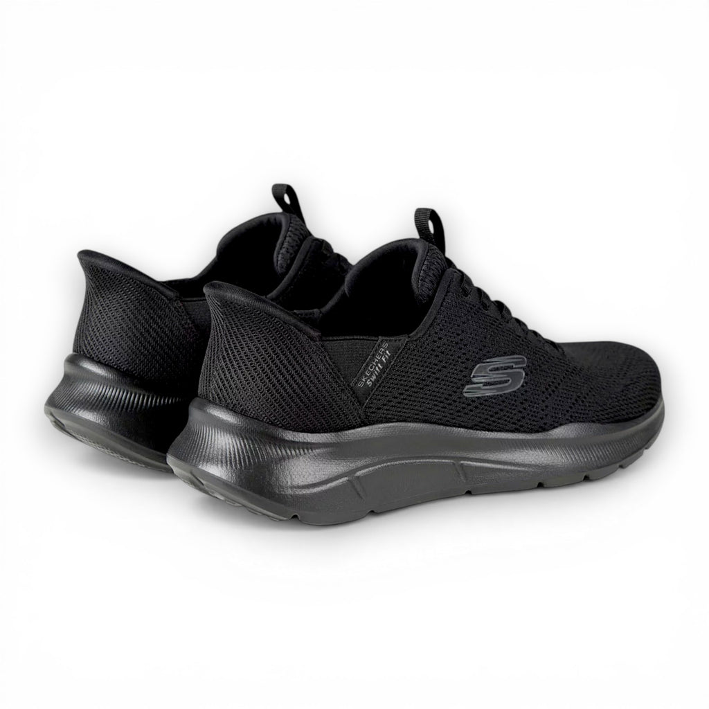 Black athletic shoes with a visible brand logo on a white background