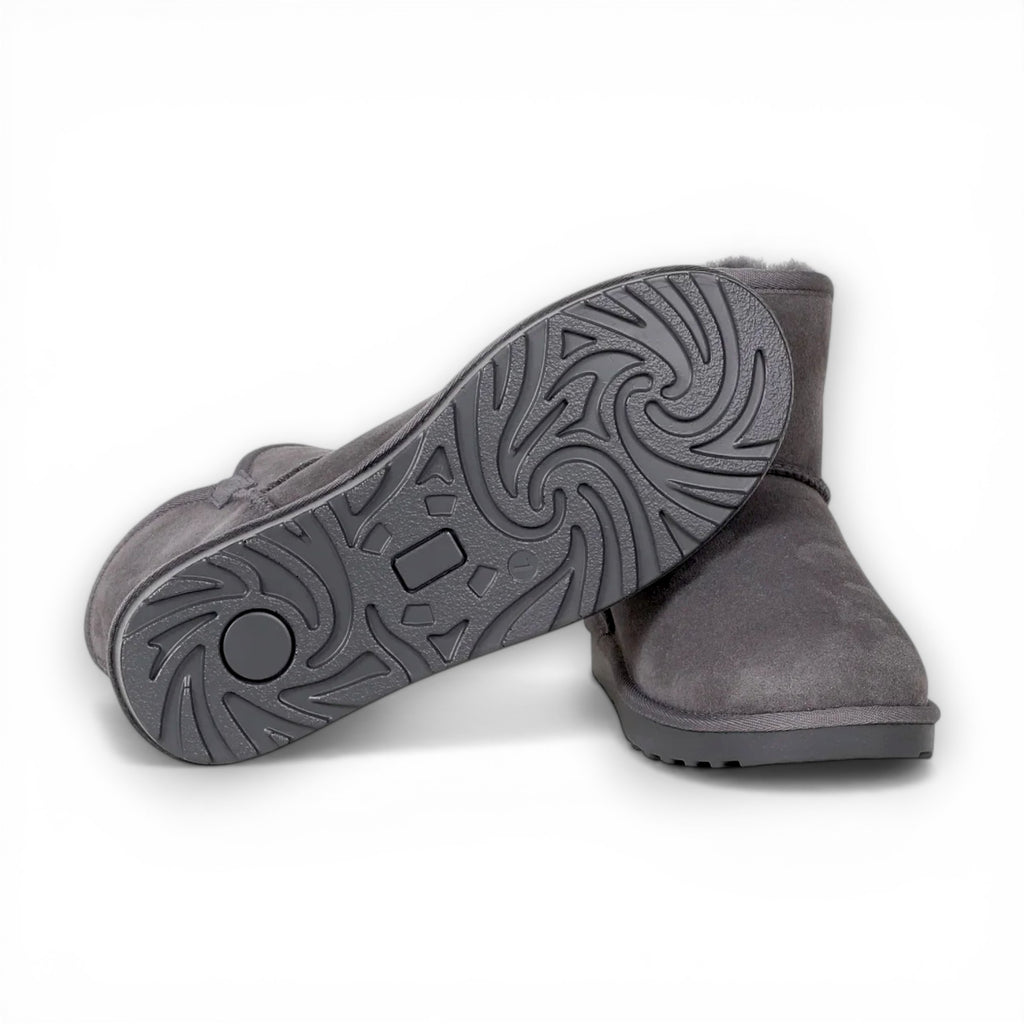 Gray suede shoes with a focus on the sole on a white background