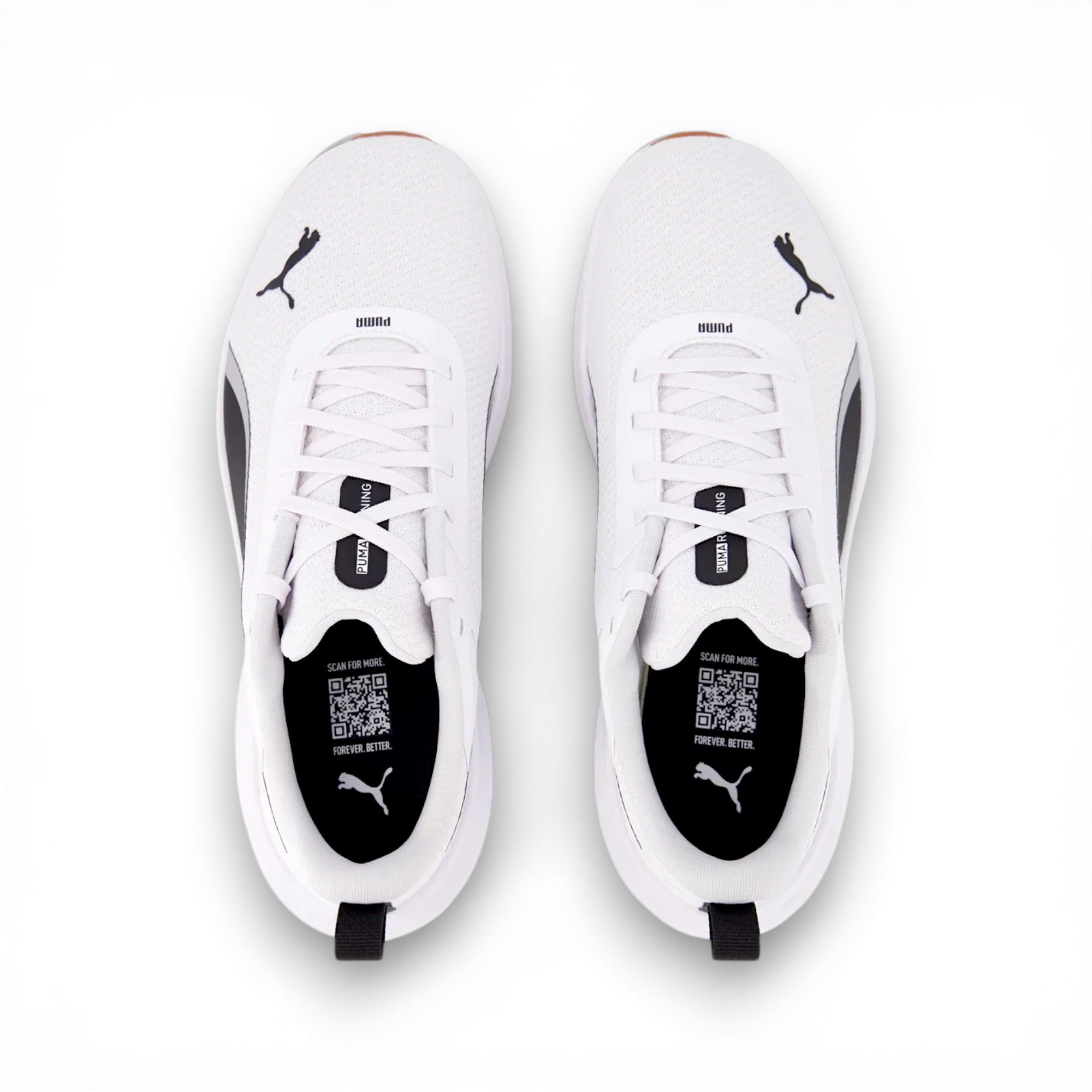White Puma sneakers with black soles on a white background