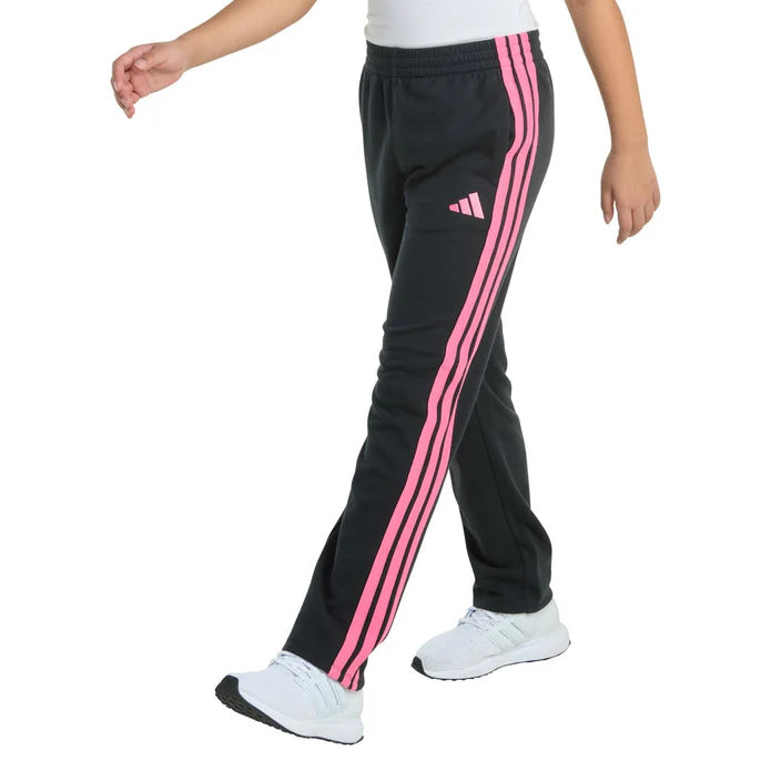 Black track pants with pink stripes worn by a person on a white background