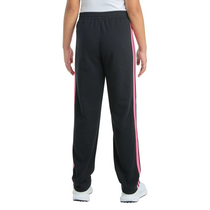 Black track pants with pink stripes worn by a person on a white background