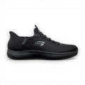 Black athletic shoe with red sole on a white background
