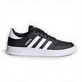 Black Adidas sneaker with white stripes on a white background