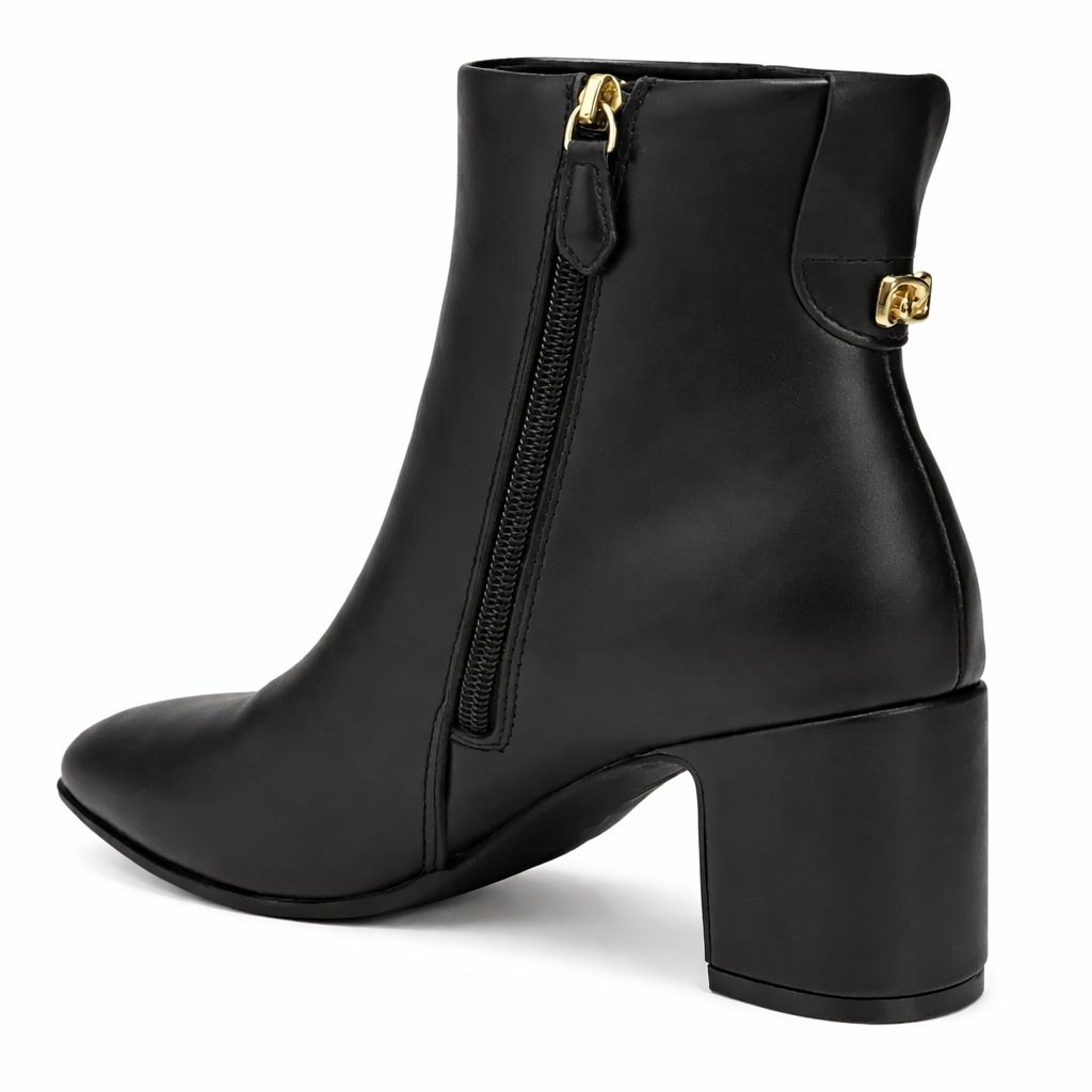 Black ankle boot with gold zipper on a white background