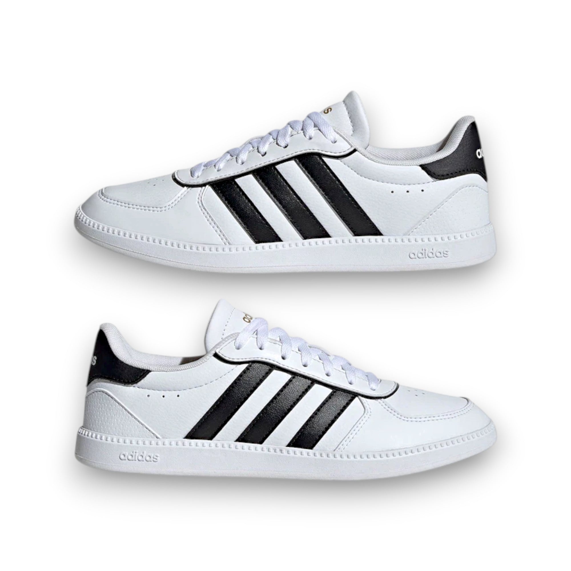 White sneakers with black stripes on a white background